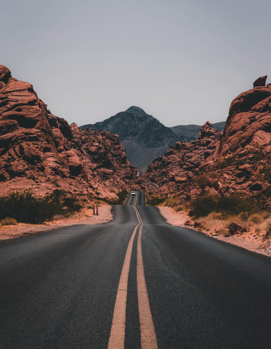 A lone figure moving through a vast sunlit landscape